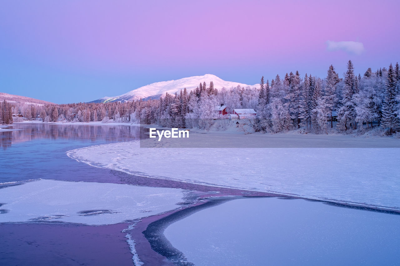 FROZEN LAKE AGAINST SKY DURING WINTER