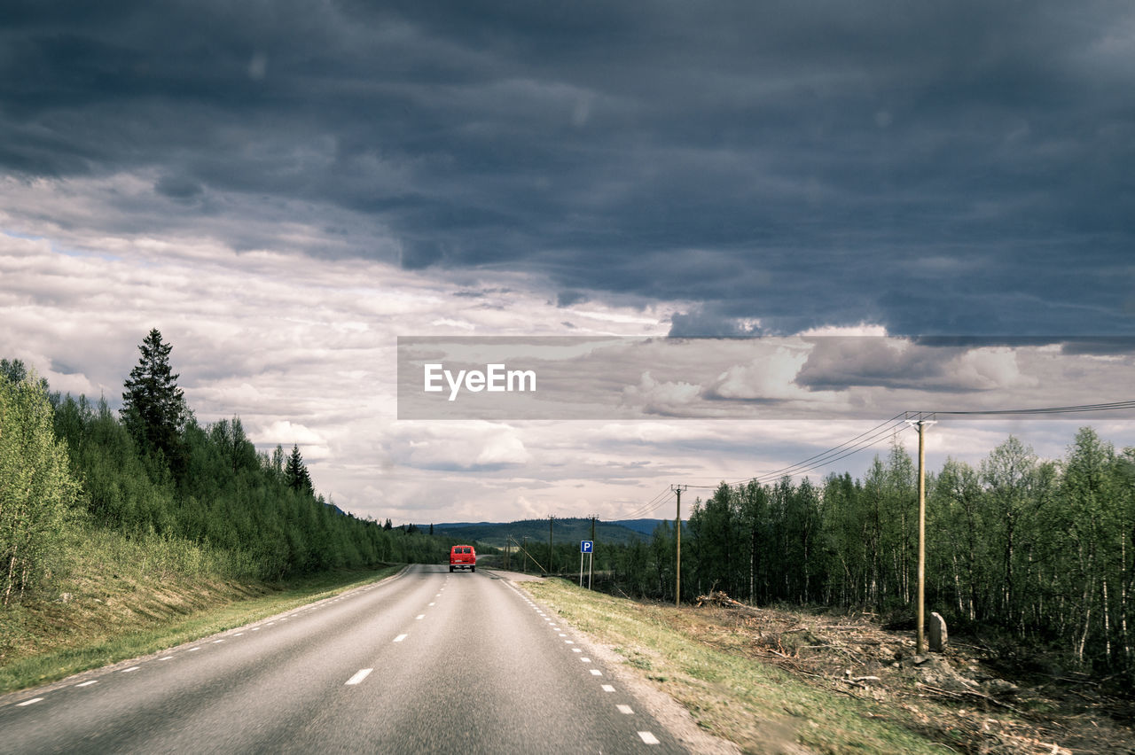 Road by highway against sky