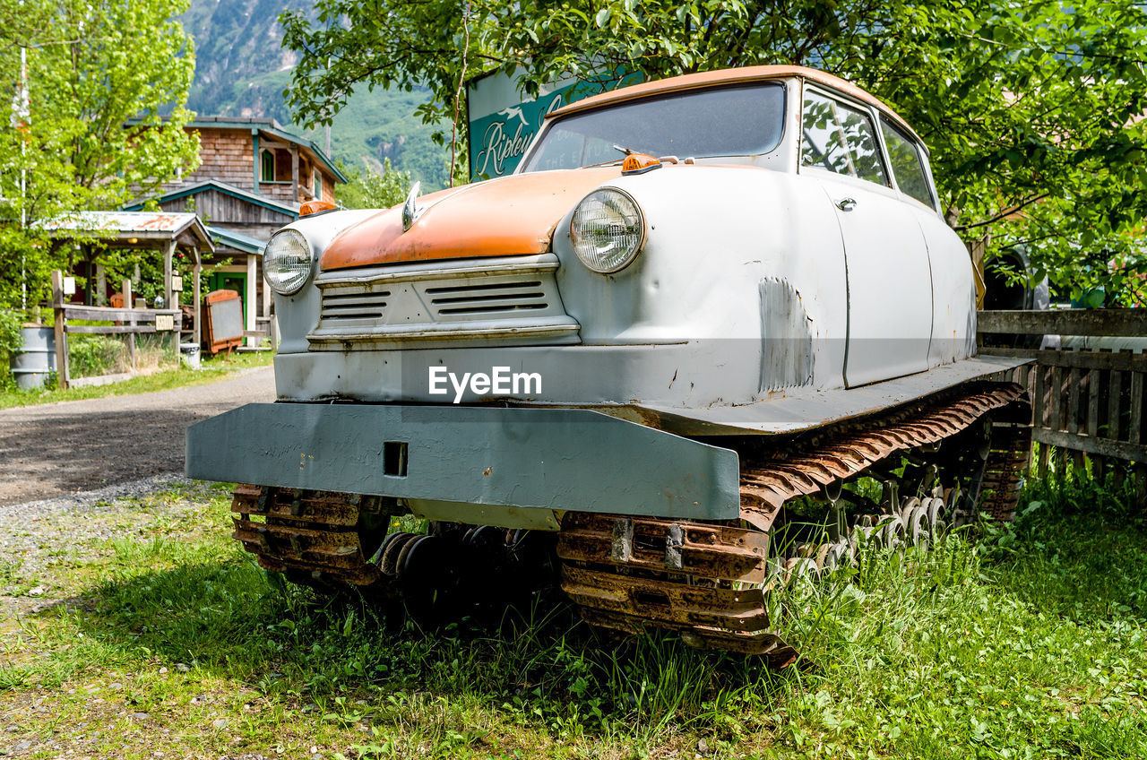 Antique snowmobile on grassy field