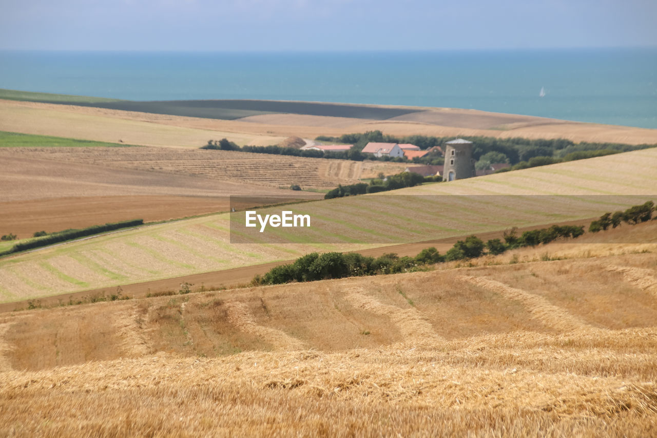 Scenic view of agricultural field and the channel against sky in escalles