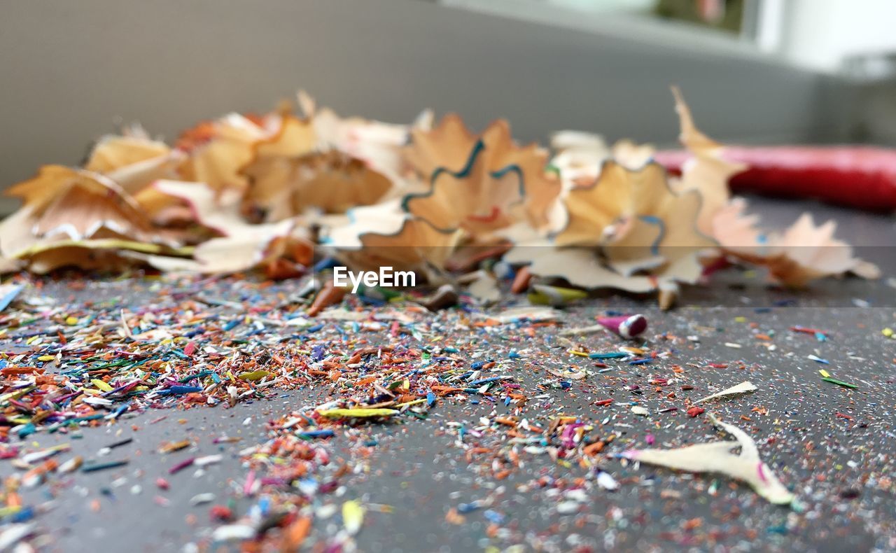 Close-up of multi colored pencil shavings on table