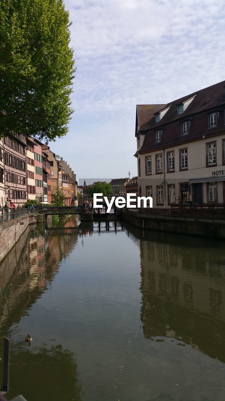 REFLECTION OF BUILDINGS IN RIVER