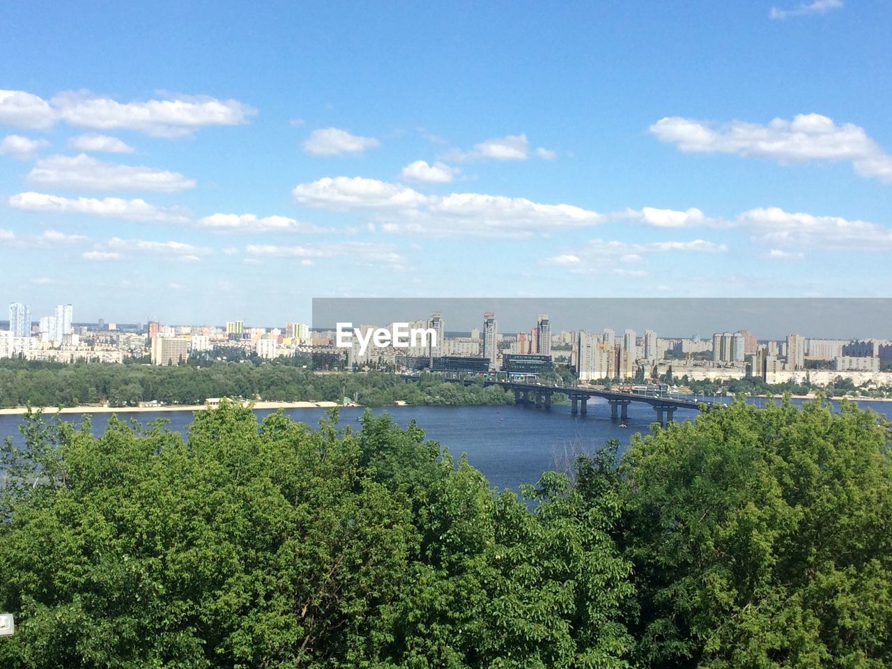 Scenic view of river and cityscape against sky