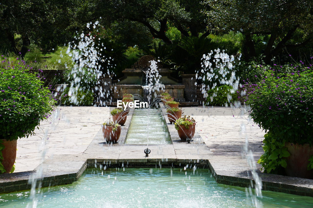 Fountain and potted plants in park