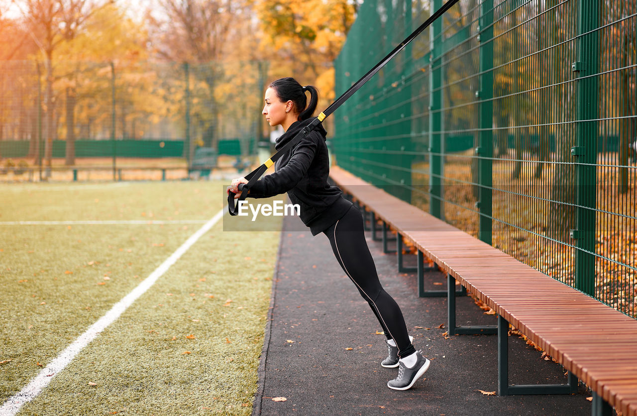 Full length side view of woman exercising