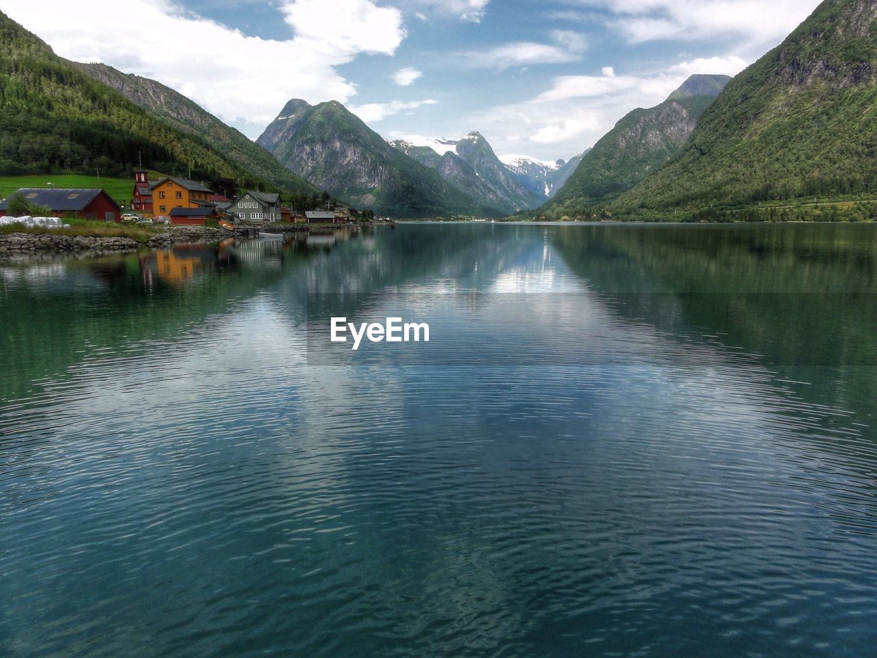 Scenic view of lake and mountains against sky