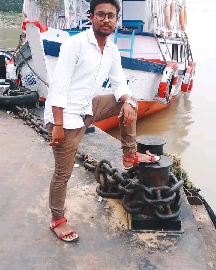 water, transportation, mode of transportation, men, full length, adult, one person, footwear, vehicle, looking at camera, young adult, portrait, smiling, nautical vessel, occupation, day, casual clothing, standing, boat, person, front view, happiness, emotion, clothing, nature, ship, outdoors, working