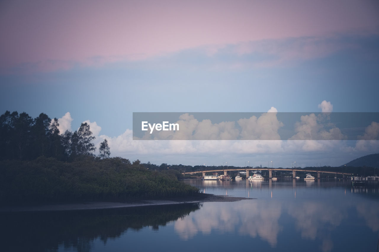 Scenic view of river against sky at sunset