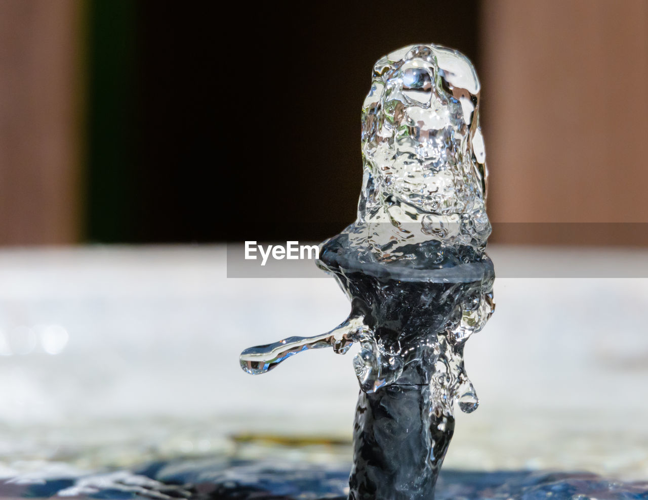 CLOSE-UP OF WATER SPRAYING FROM FAUCET