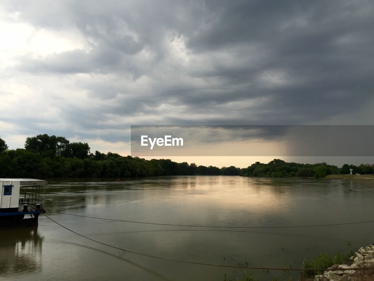 Scenic view of lake against cloudy sky