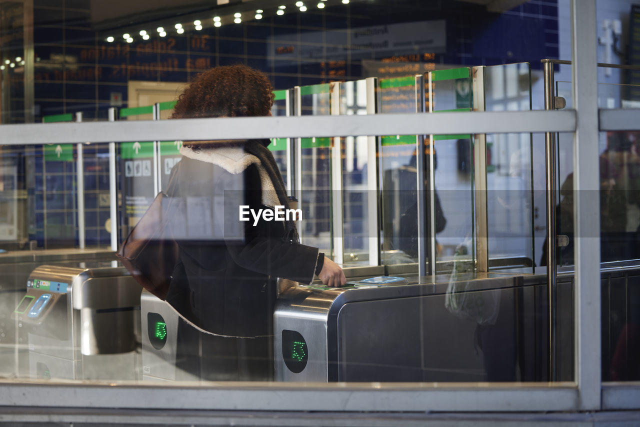 Woman at ticket barrier at train station