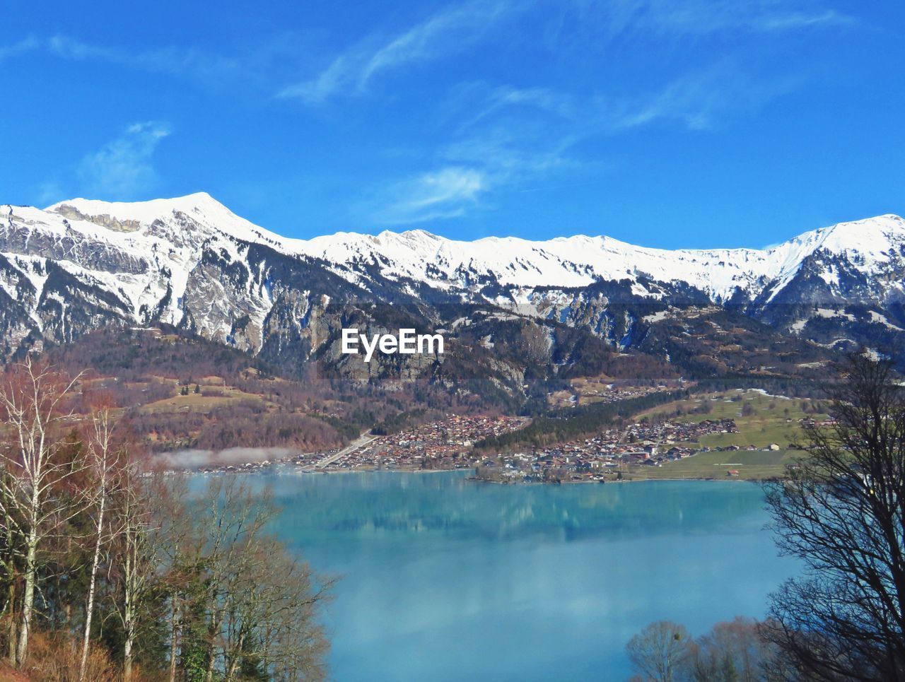 SCENIC VIEW OF LAKE BY SNOWCAPPED MOUNTAIN AGAINST SKY