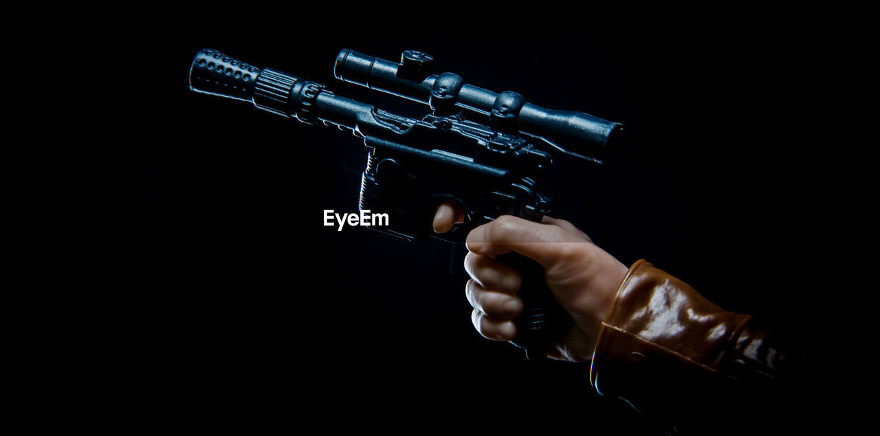 gun, hand, weapon, one person, studio shot, handgun, black background, aggression, firearm, indoors, holding, violence, adult, aiming, security, protection, communication, warning sign