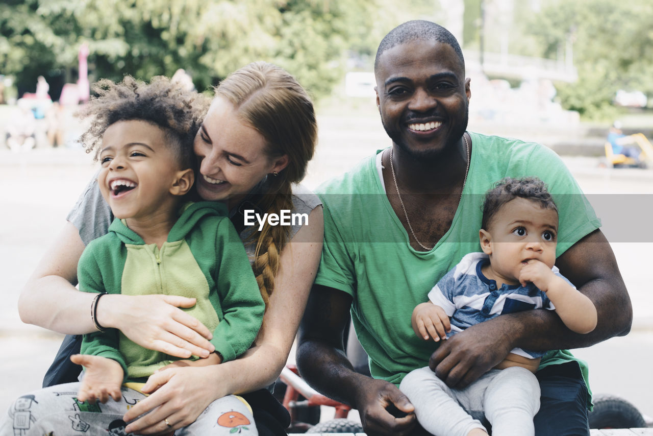 Happy family sitting at park