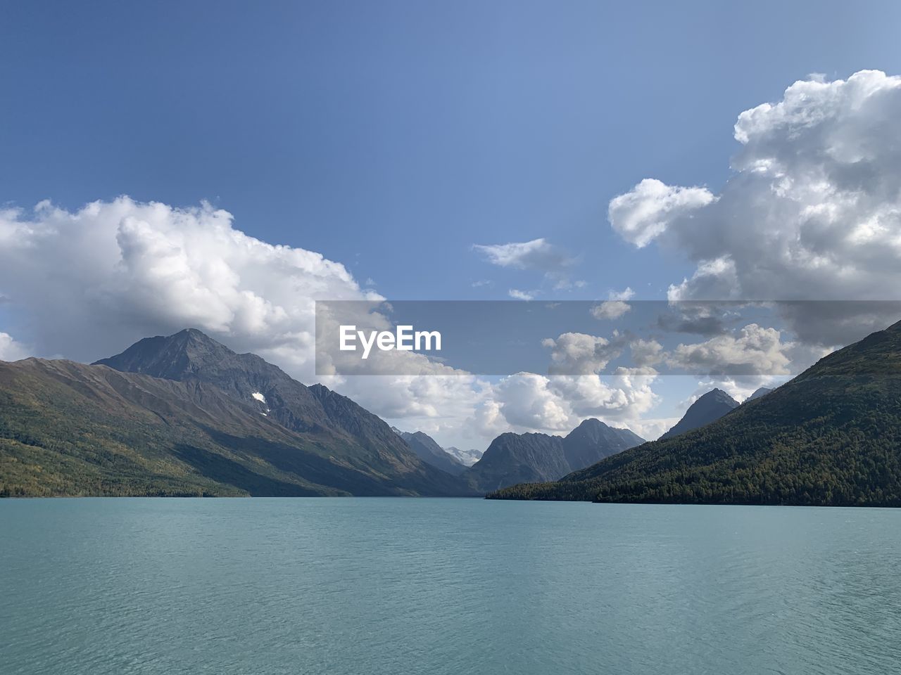 Scenic view of lake and mountains against sky