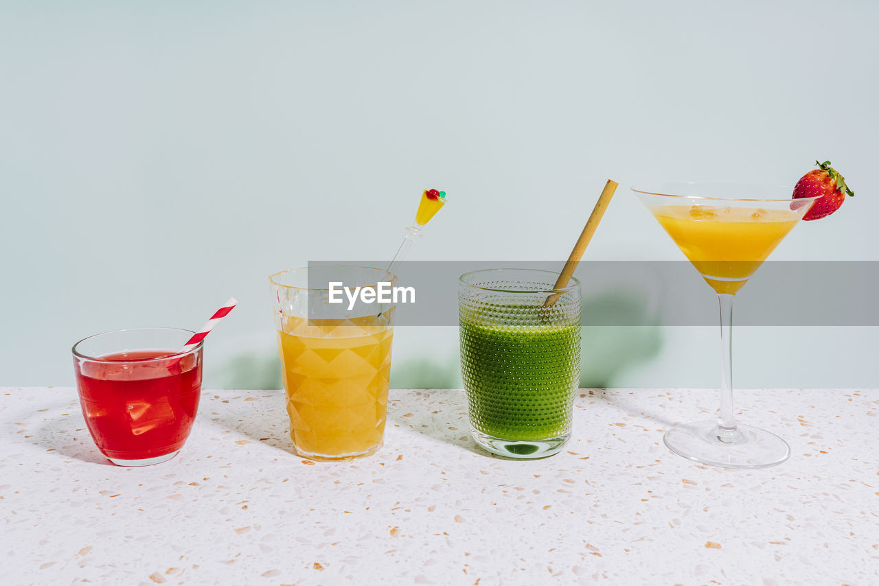 Healthy summer cocktails on terrazzo marble against wall at home