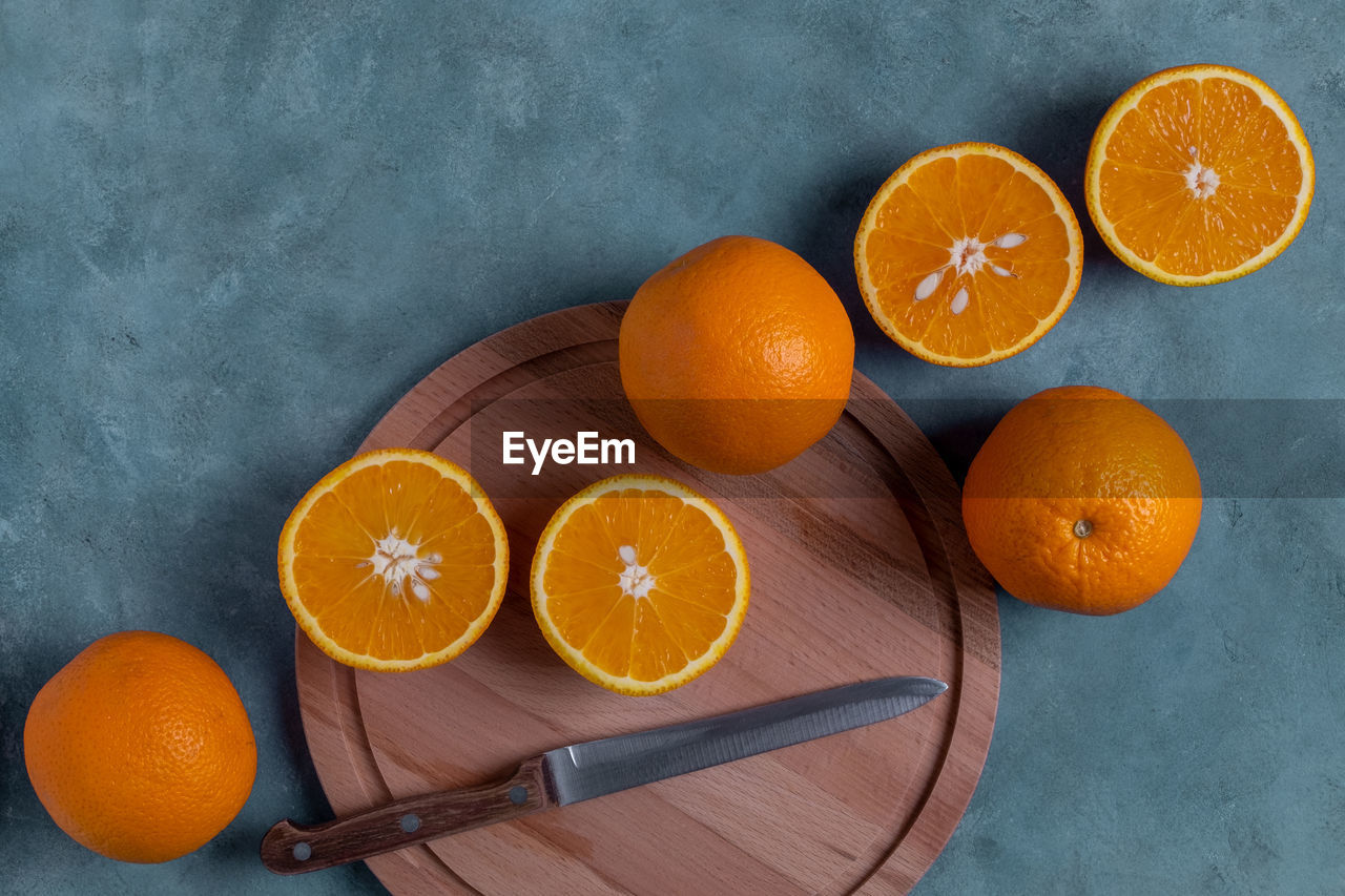 Close-up top view of ripe whole and halved oranges. selective focus.