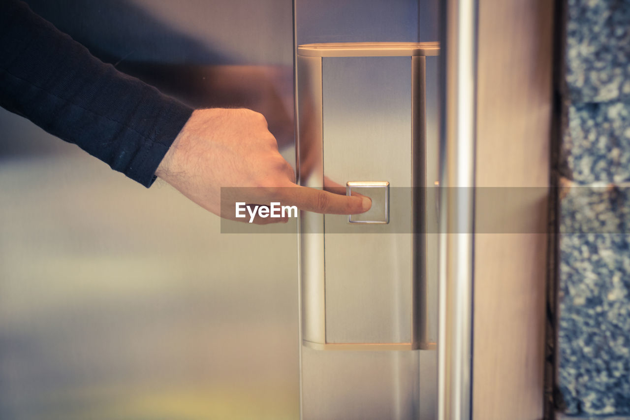 CLOSE-UP OF HAND HOLDING DOOR