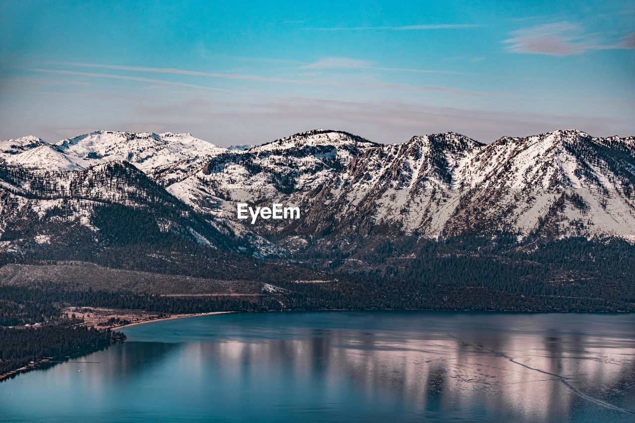 Scenic view of lake and snowcapped mountains against sky