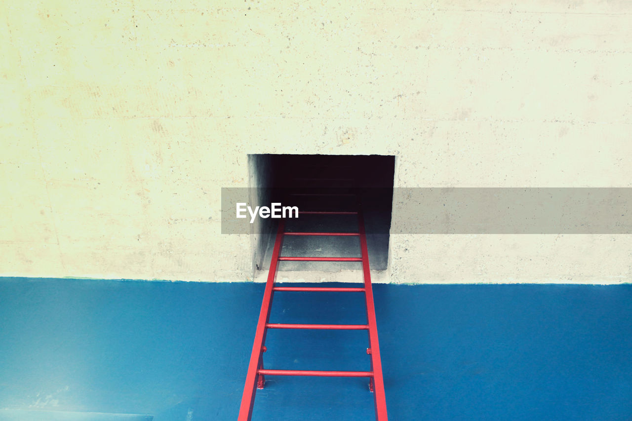 Low angle view of ladder on building wall