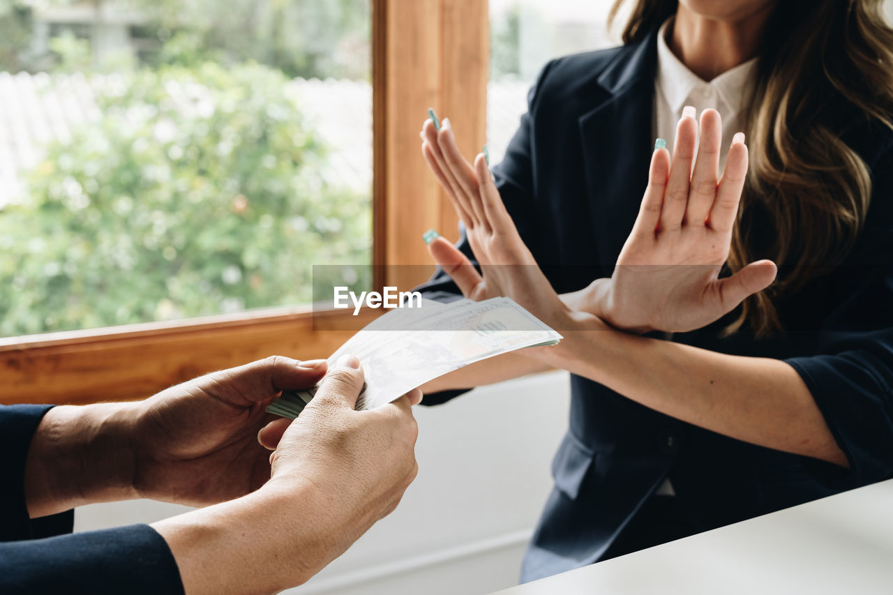 adult, women, hand, business, indoors, person, two people, communication, female, document, clothing, business finance and industry, holding, conversation, young adult, sitting, men, day, paper, businesswoman, table, lifestyles, writing, window, activity, meeting, focus on foreground, togetherness