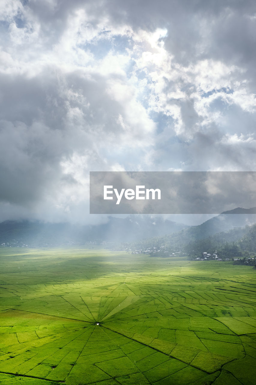 Aerial view of agricultural field against sky