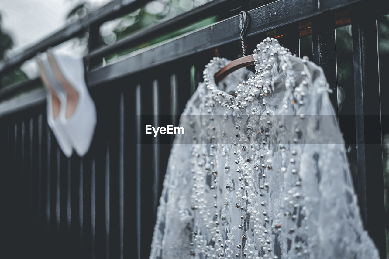 Close-up of clothes hanging on window at store