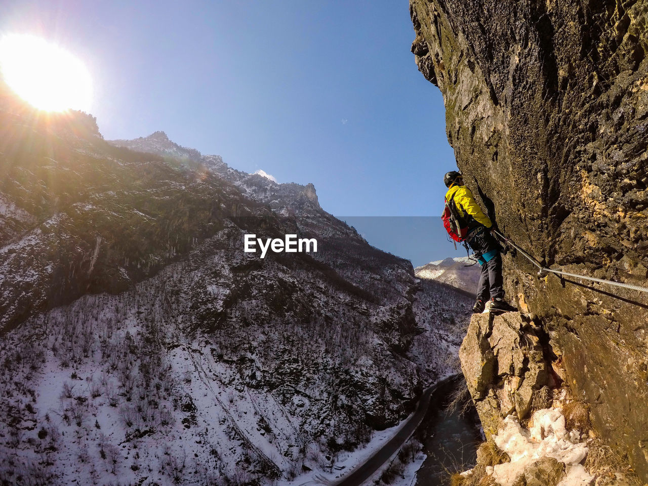 Full length of man climbing on mountain during winter