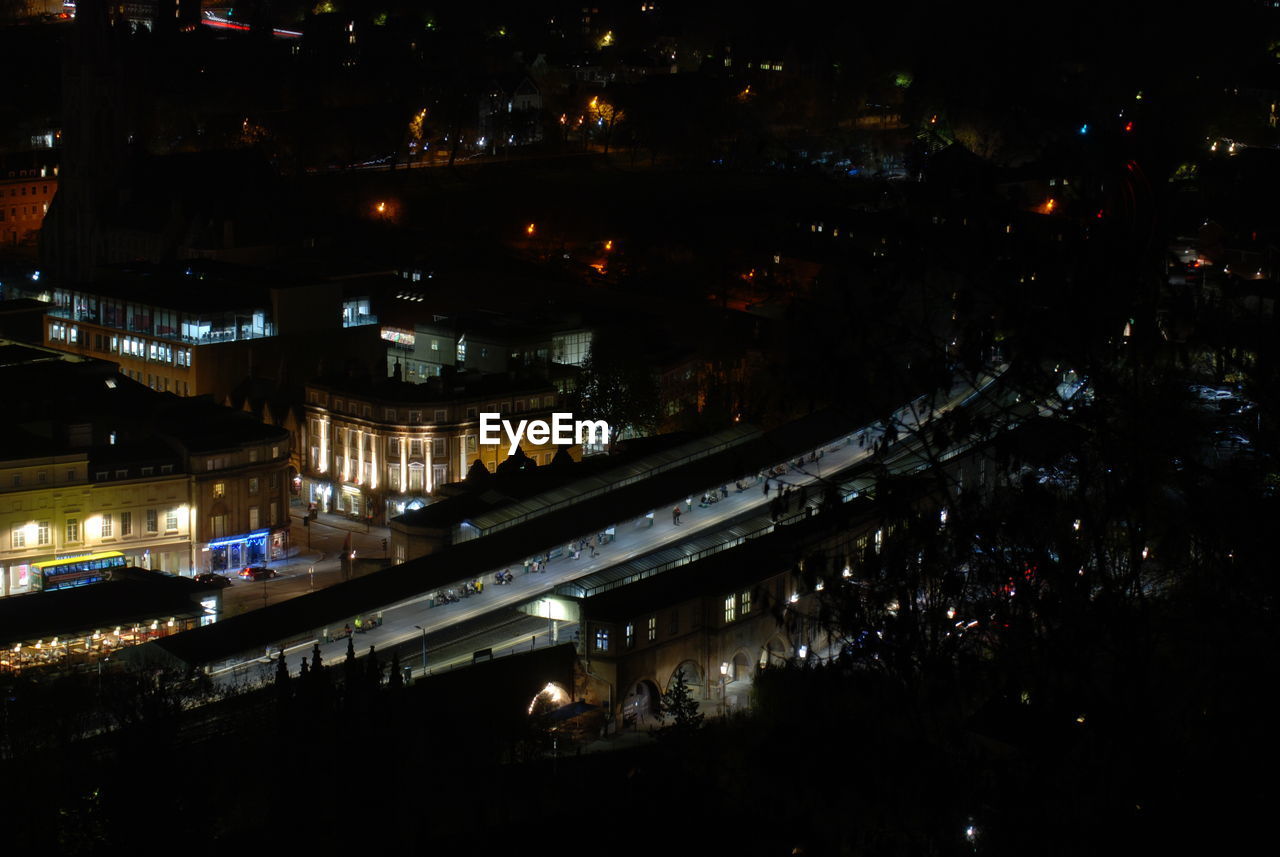 HIGH ANGLE VIEW OF ILLUMINATED BUILDINGS IN CITY