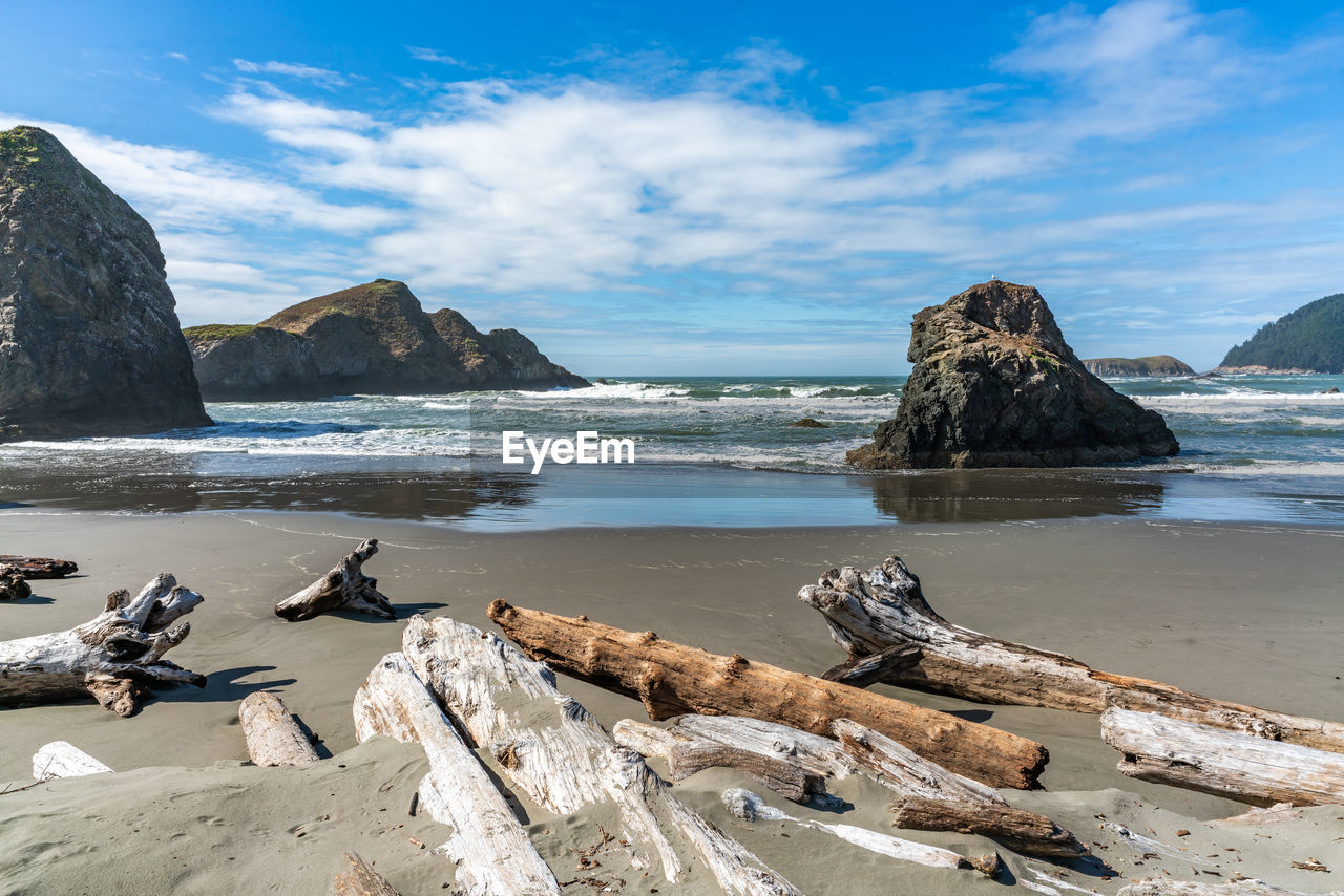 A view of meyers creek beach with waves and rock formations on the coast of oregon state.