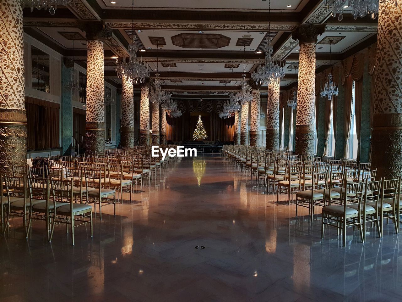 Empty chairs and tables in illuminated building