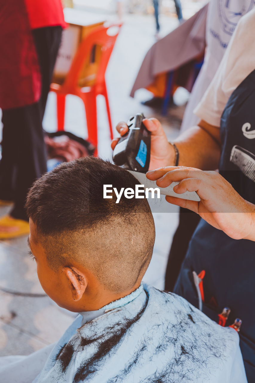 Boy getting haircut at salon