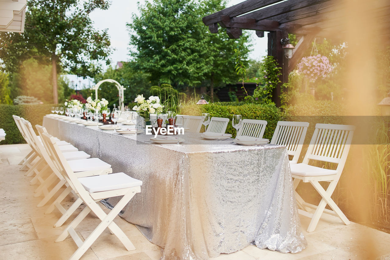 EMPTY CHAIRS AND TABLES AT YARD