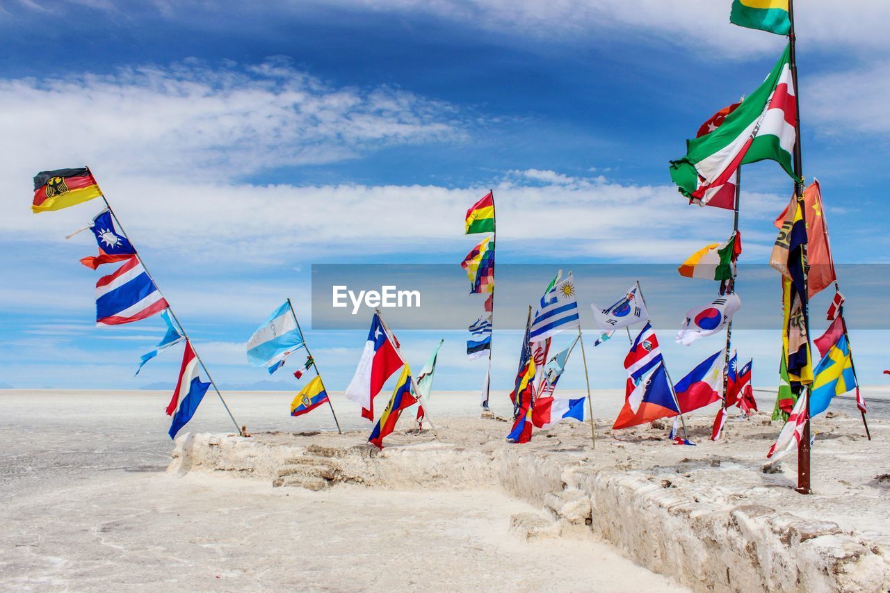 Waving flags of different countries at the entry of salar de uyunu, bolivia