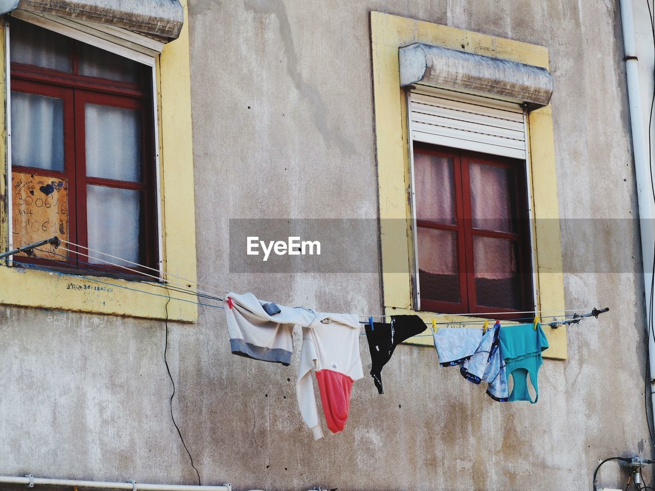 Low angle view of clothes drying against building