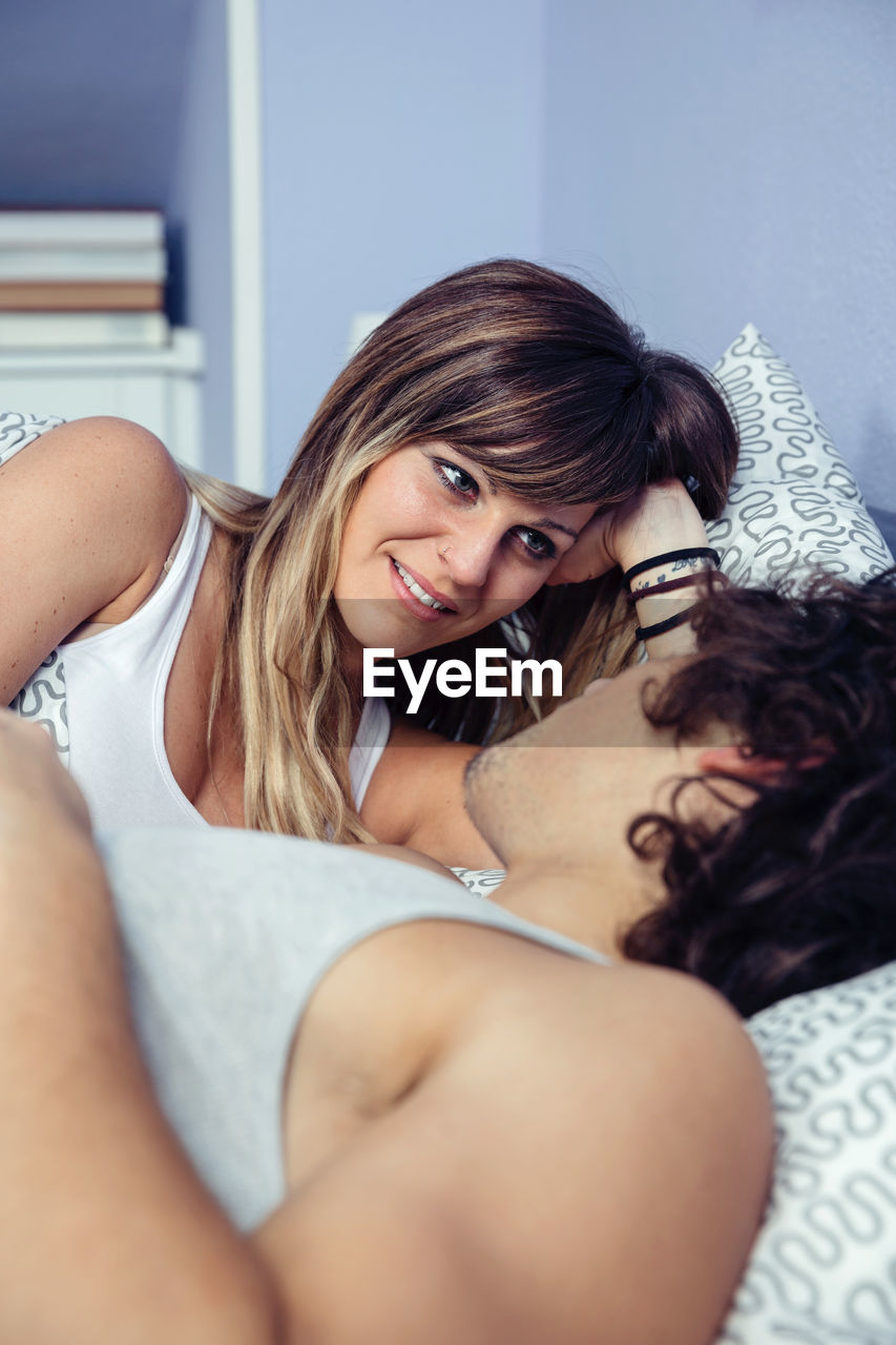 Close-up of loving couple relaxing on bed