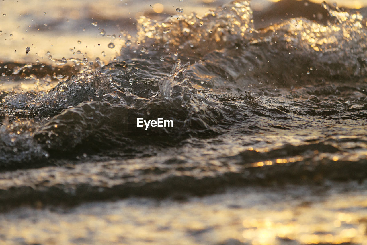 CLOSE-UP OF WATER DROP ON SEA SHORE