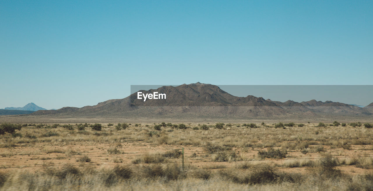 Scenic view of mountains against clear blue sky