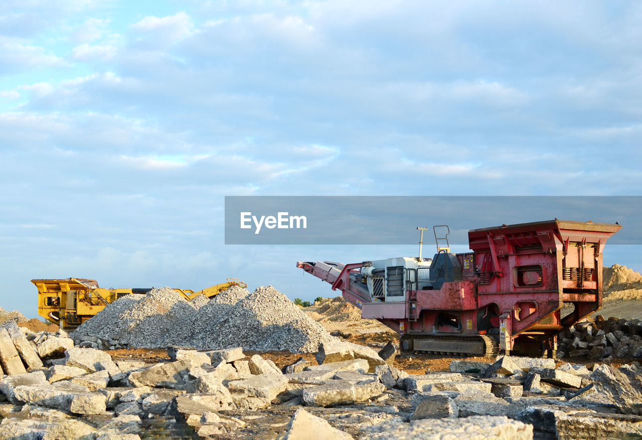 ABANDONED TRAIN ON ROCKS AGAINST SKY