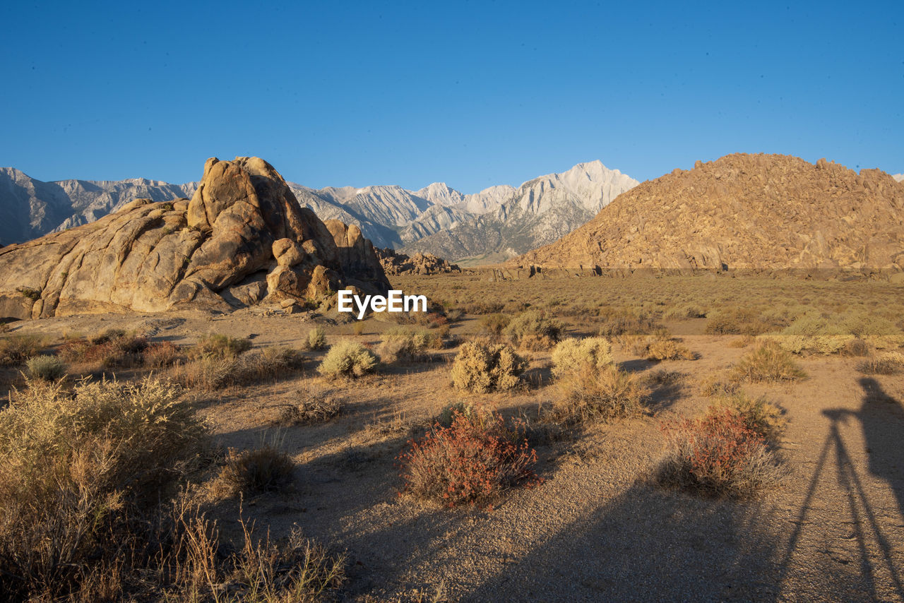 Scenic view of rocky mountains against clear blue sky