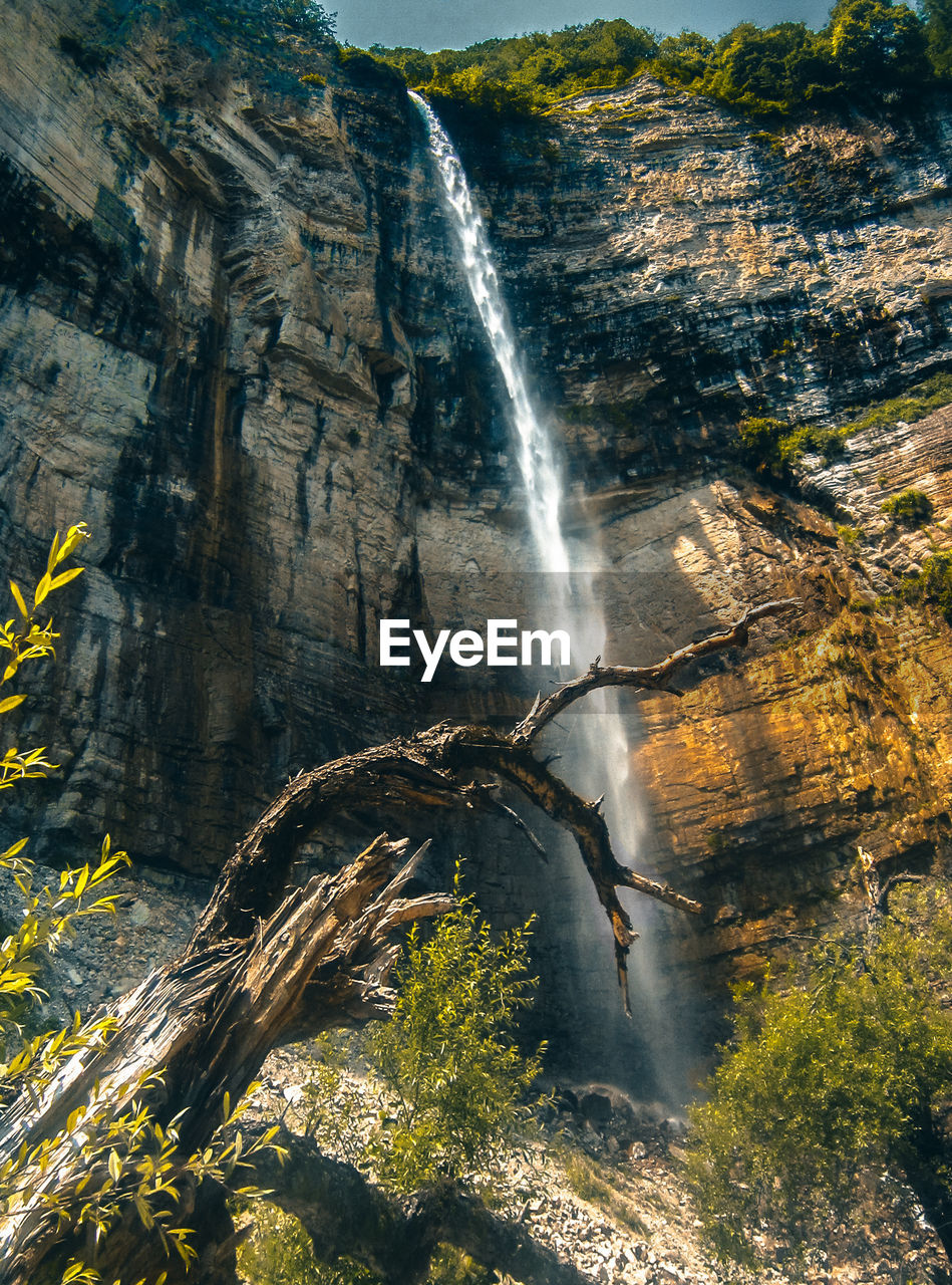 View of waterfall on rocks