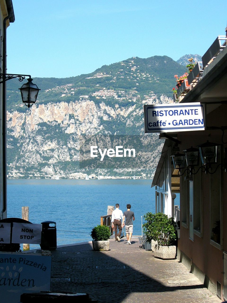 INFORMATION SIGN BY SEA AGAINST SKY IN CITY