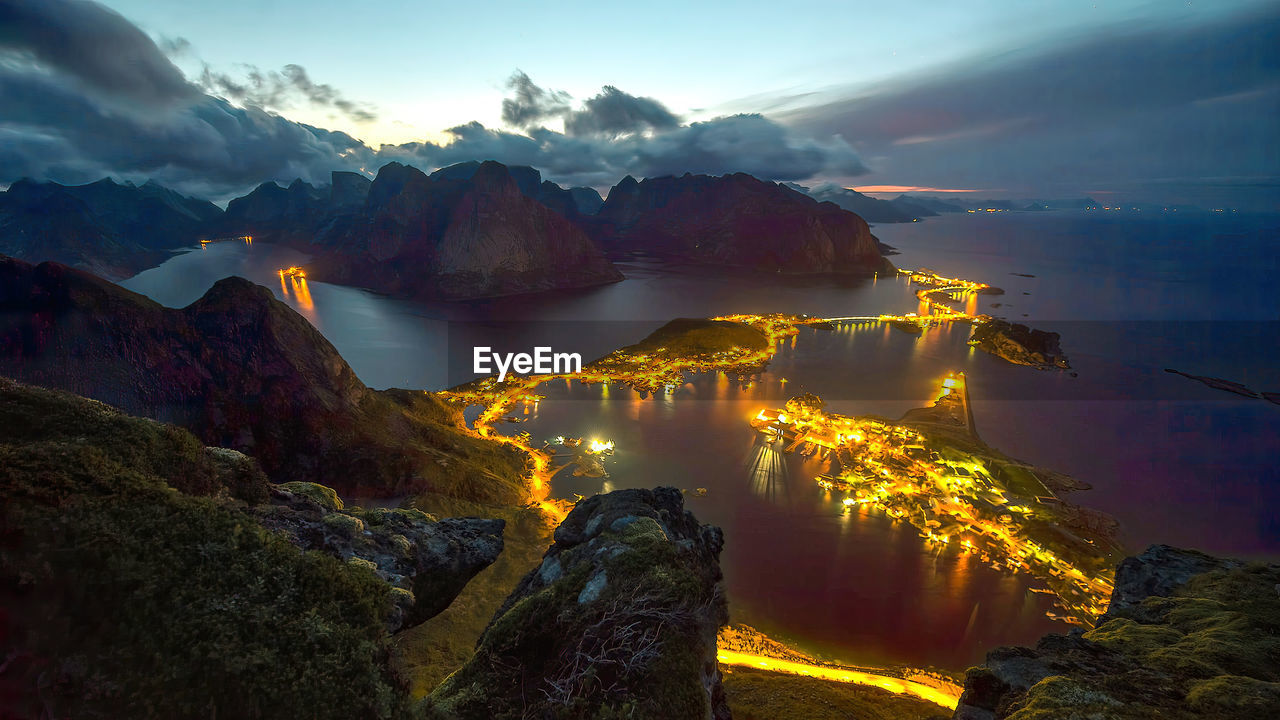 High angle view of townscape by sea against sky during sunset