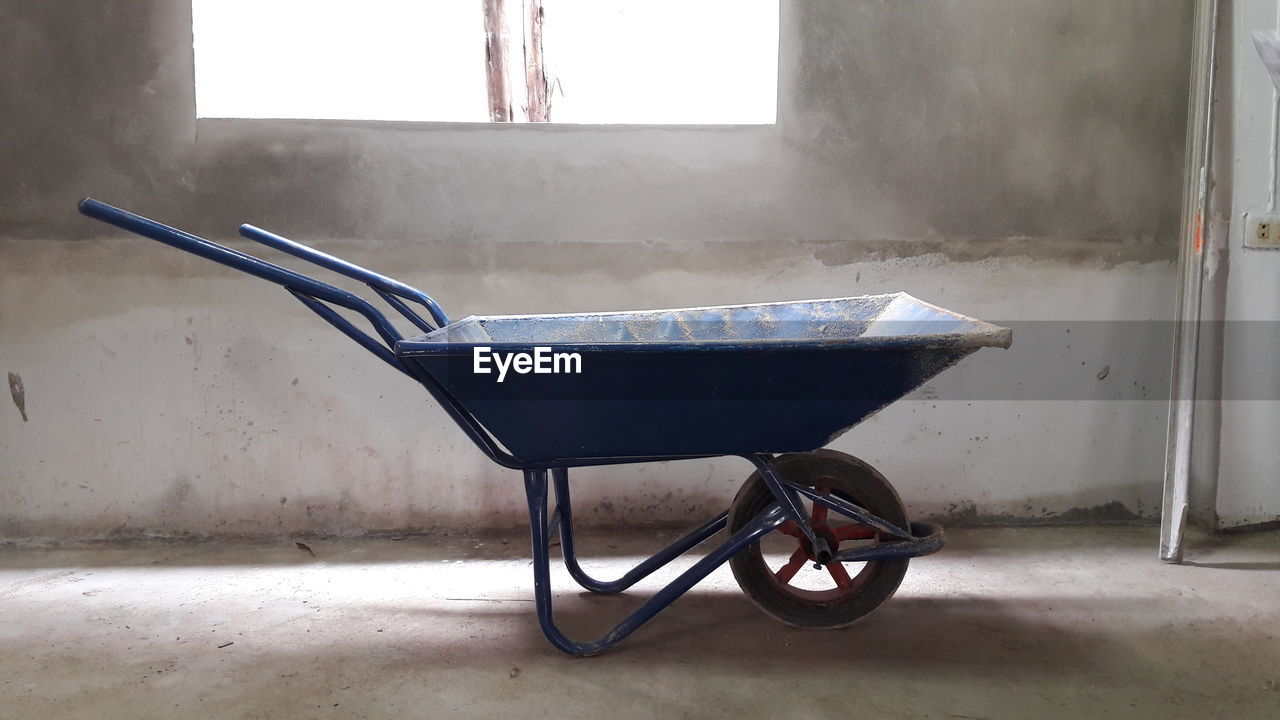 Wheelbarrow by window