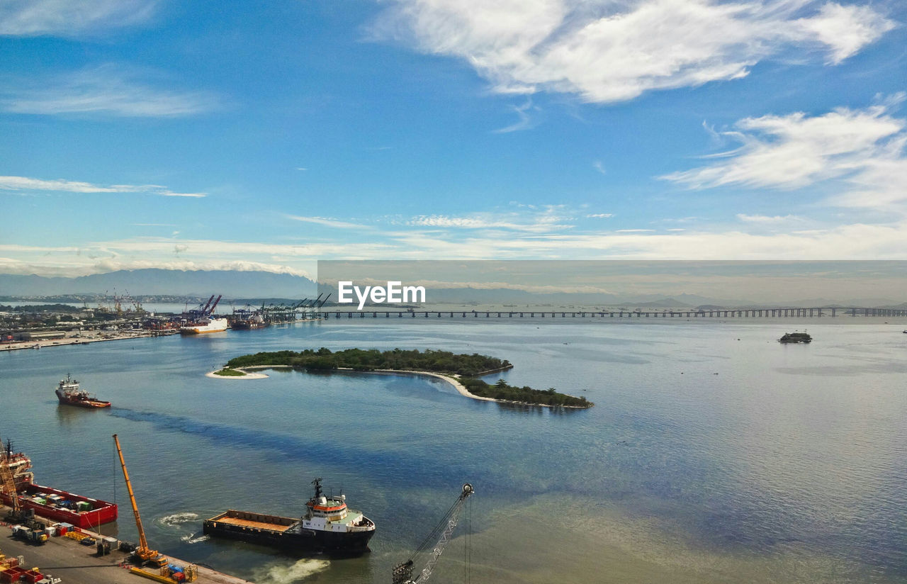 High angle view of boats at harbor against sky