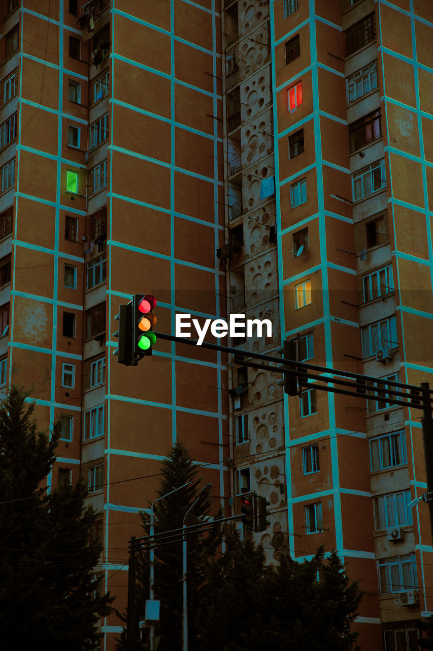 Building with colorful window lights and traffic lights on