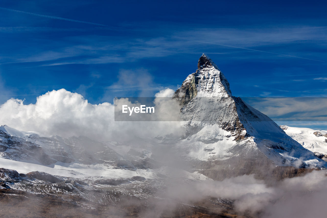 Aerial view of snowcapped mountain against sky