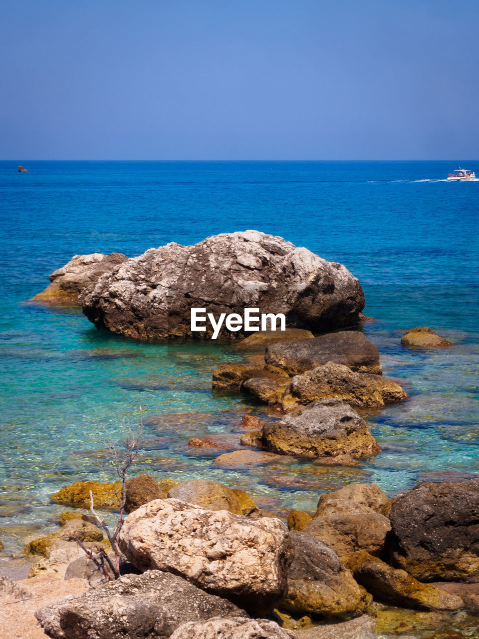 Rock formation in sea against sky