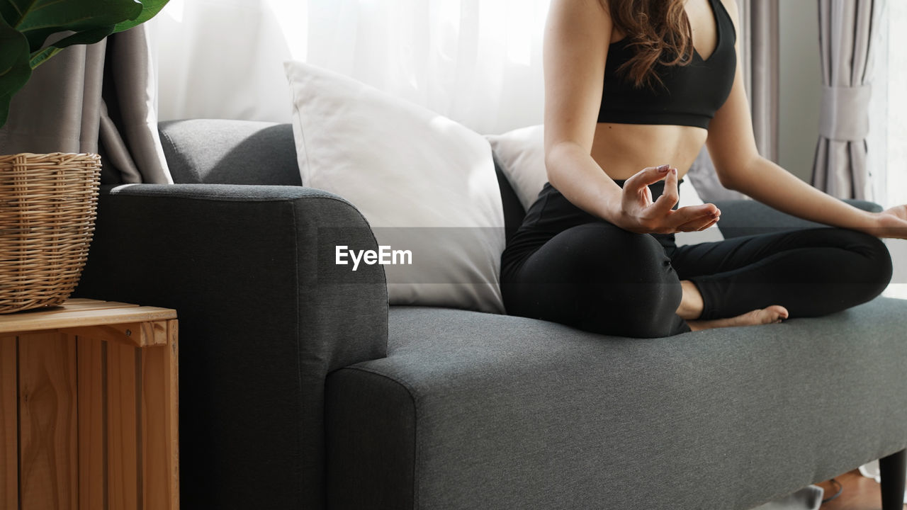 Yoga exercise at home concept. asian young woman doing yoga in the living room at home to relax 