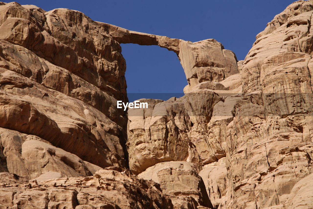 Low angle view of natural arch in desert against sky